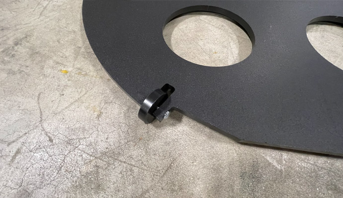 Black metal conduit spacer plate with clamp
