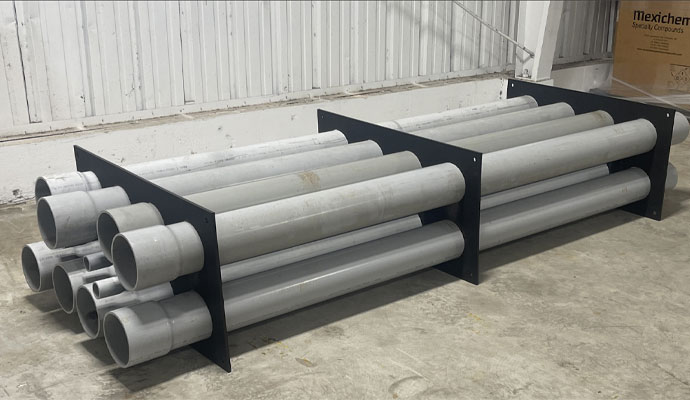 PVC conduits secured in black spacer rack indoors