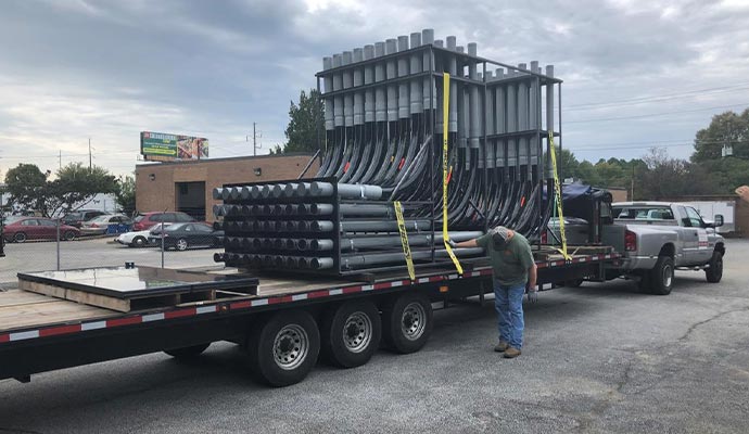 Conduits with spacers kept on a lowbed trailer
