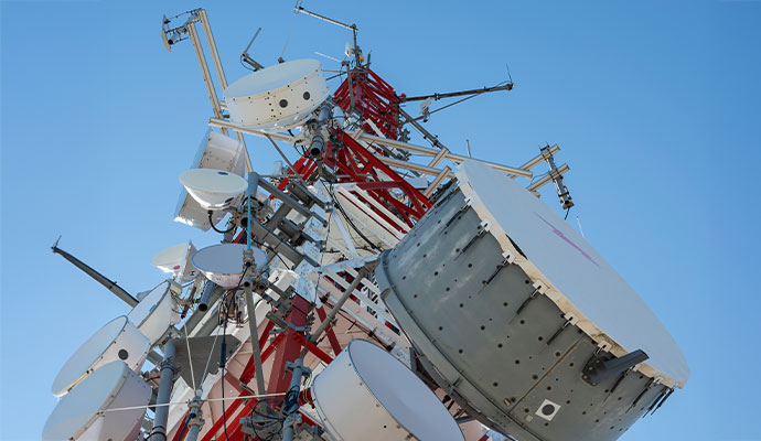 A large cell tower with microwave antennas of telecommunication industry