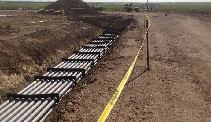 Multiple electrical conduits secured in trench with spacers before concrete placement