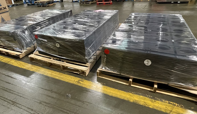 Pallets of plastic duct bank spacers wrapped for warehouse shipment